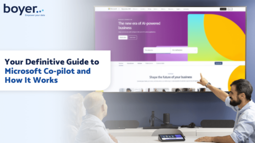 Image for a guide on Microsoft Co-pilot, showing a person pointing at a screen displaying the Microsoft Dynamics website